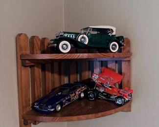 Model cars on corner wall shelf 