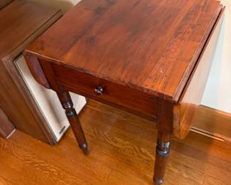 Antique occasional table with drawer and two drop leaves. When closed as shown 18 inches wide by 18 inches deep by 29 inches high. As found needs some touching up on the top surface. When open the table is 40 inches wide by 18 deep by 29 1/2 high.