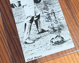This lot features a collectible vintage black-and-white photograph or postcard featuring baseball catcher Chief Meyers in a throwing stance at the Polo Grounds. The image is dated 1909 and features his name, a printed signature, and a handwritten-style note.