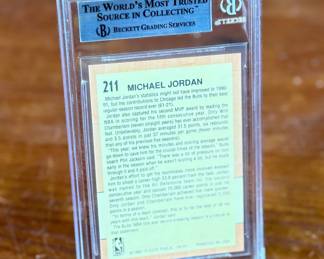 This lot features a graded 1991-92 Fleer #211 Michael Jordan NBA All-Star Team basketball card. Beckett graded 8.5.