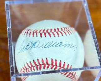 This lot features an autographed baseball signed by Hall of Fame baseball player Ted Williams. Comes in a display case.