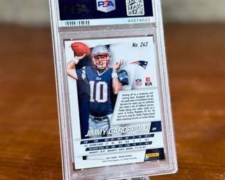 This lot features a 2014 Panini Prizm Silver Prizm #243 Jimmy Garoppolo Rookie Card, graded by PSA as a Near Mint 7. 
