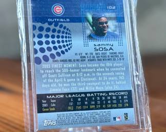 This lot features a 2004 Topps Finest Sammy Sosa baseball card featuring a game-worn jersey swatch. 