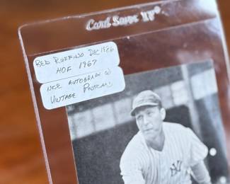 This lot features a vintage, autographed postcard featuring Hall of Fame pitcher Red Ruffing, protected in a rigid plastic card saver. 