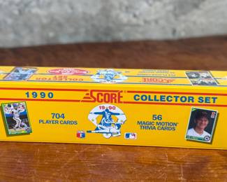 This lot features a 1990 Score Baseball Collector Set containing 704 player cards and 56 “Magic Motion” trivia cards. Still sealed in original plastic wrap. Features iconic cards like the Bo Jackson “shoulder pads” card and Frank Thomas rookie card.
