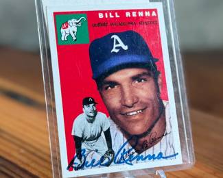 This lot features a 1954 Topps baseball card featuring Bill Renna of the Philadelphia Athletics. The card is signed on the front and also includes an additional signature on paper shown in the verso photo.