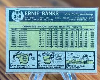 This lot features a vintage 1961 Topps #350 Ernie Banks Chicago Cubs baseball card.