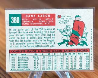 This lot features a 1959 Topps #380 Hank Aaron baseball card. It is a collectible item featuring the Hall of Famer in his Milwaukee Braves uniform.