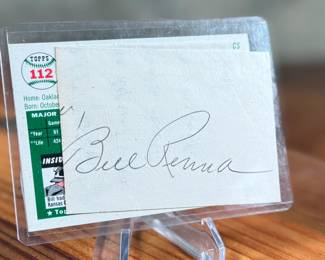 This lot features a 1954 Topps baseball card featuring Bill Renna of the Philadelphia Athletics. The card is signed on the front and also includes an additional signature on paper shown in the verso photo.