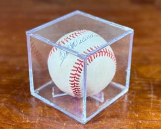This lot features an autographed baseball signed by Hall of Fame baseball player Ted Williams. Comes in a display case.