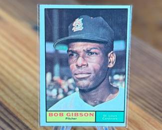 This lot features a 1961 Topps Bob Gibson #211 baseball card featuring the Hall of Fame pitcher for the St. Louis Cardinals. 