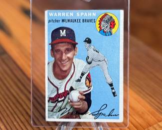 This lot features a collectible 1954 Topps #20 Warren Spahn baseball card featuring the Hall of Fame Milwaukee Braves pitcher. 