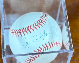 This lot features a signed baseball by Cal Ripken Jr., 2007 Hall of Famer with 3,184 career hits. Comes in a display case.