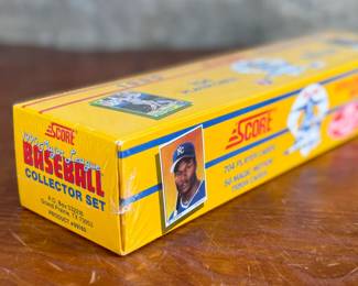 This lot features a 1990 Score Baseball Collector Set containing 704 player cards and 56 “Magic Motion” trivia cards. Still sealed in original plastic wrap. Features iconic cards like the Bo Jackson “shoulder pads” card and Frank Thomas rookie card.