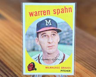 This lot features a vintage 1959 Topps baseball card featuring Milwaukee Braves pitcher Warren Spahn. 