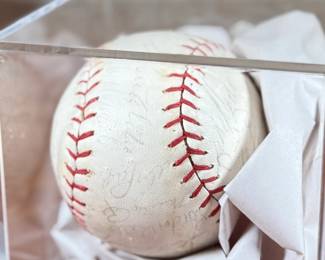 This lot features a baseball with twenty-six (26) autographs from the 1965 Los Angeles Dodgers. Notable signatures include Walter Alston, Don Drysdale, and Sandy Koufax. Accompanied in a display case with authentication papers from Beckett.