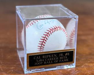 This lot features a signed baseball by Cal Ripken Jr., 2007 Hall of Famer with 3,184 career hits. Comes in a display case.