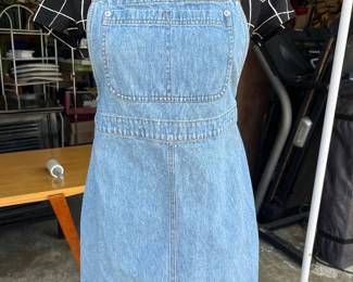 Overall dress with sample of things for sale in background 
