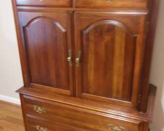 dresser with drawers behind the 2 doors