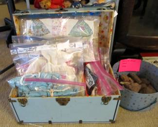 an ATQ doll cabinet full of ATQ doll clothes varying in sizes.