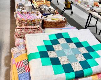 Vintage handmade quilts, small crochet items, and vintage fabric