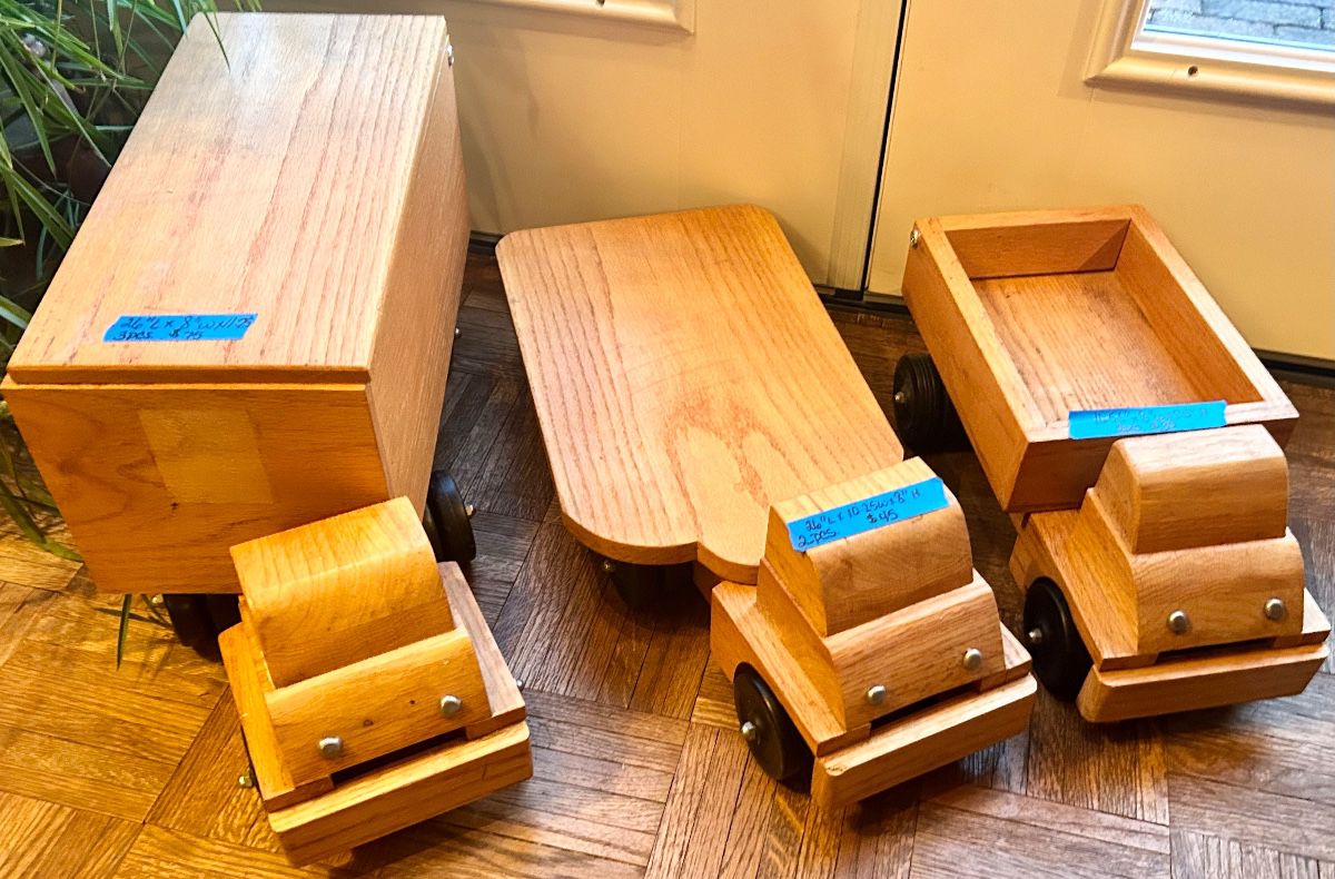 Handmade solid wood toy trucks with heavy duty wheels. Large storage truck $75 flatbed truck $50, dump truck $35.
