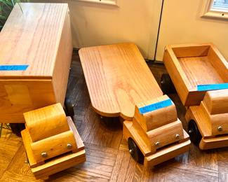 Handmade solid wood toy trucks with heavy duty wheels. Large storage truck $75 flatbed truck $50, dump truck $35.