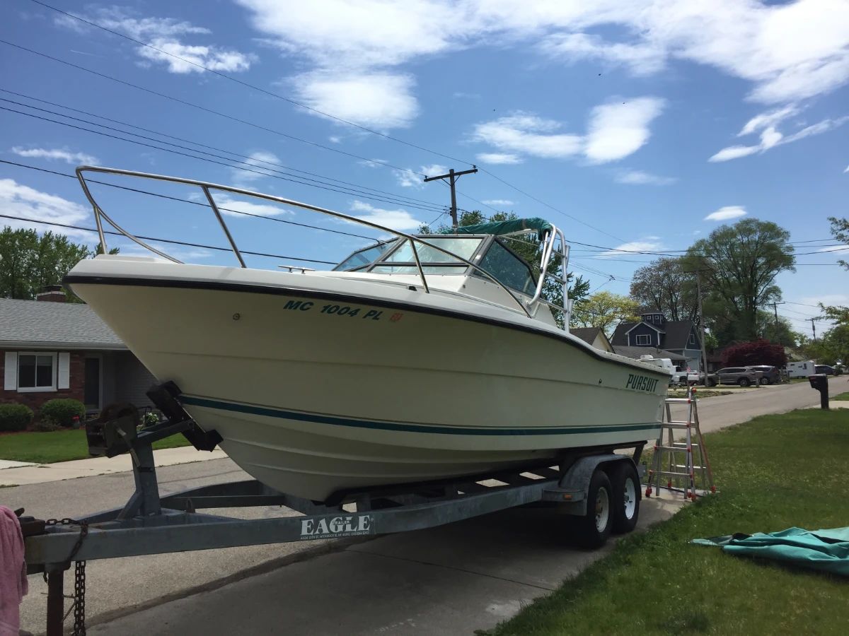 . . . 1992 Pursuit 2350, 975 hours, walk-around cuddy cabin, 5.7 Magnum engine, Mercruiser trolling motor and much more!
