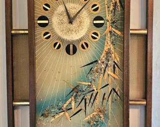MCM wall clock with distinctive wooden frame & Asian-inspired aesthetic.
