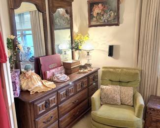Triple dresser in primary bedroom features double mirrors and includes 2 matching nightstands