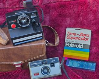 Polaroid Land Camera with SX-70 Land Film and a Kodak instamatic camera 34