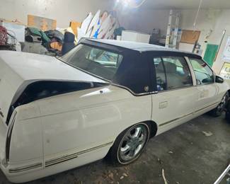1999 Cadillac DeVille featuring a white exterior, chrome wheels, and a black landau top... a classic! 