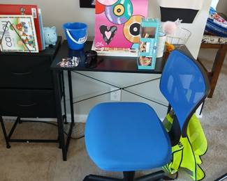 youth desk with blue chair; various wall art and posters