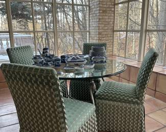 Four wicker chairs with glass top table