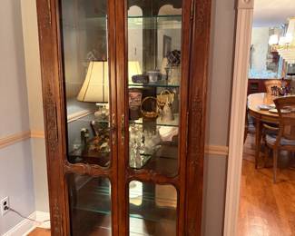 Traditional wood curio cabinet with glass doors we have two of these