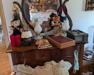 Antique hardwood furniture and children's clothing.
