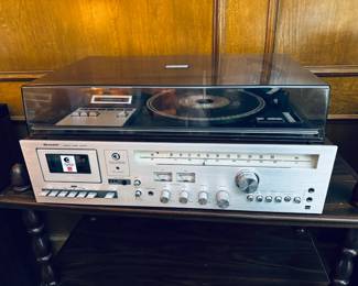 Sharp turntable, 8 track, cassette and radio player. Speakers also available. Check out all the vintage records!!