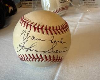 Baseball signed by Enos slaughter, Warren Spahn, and John sain.
