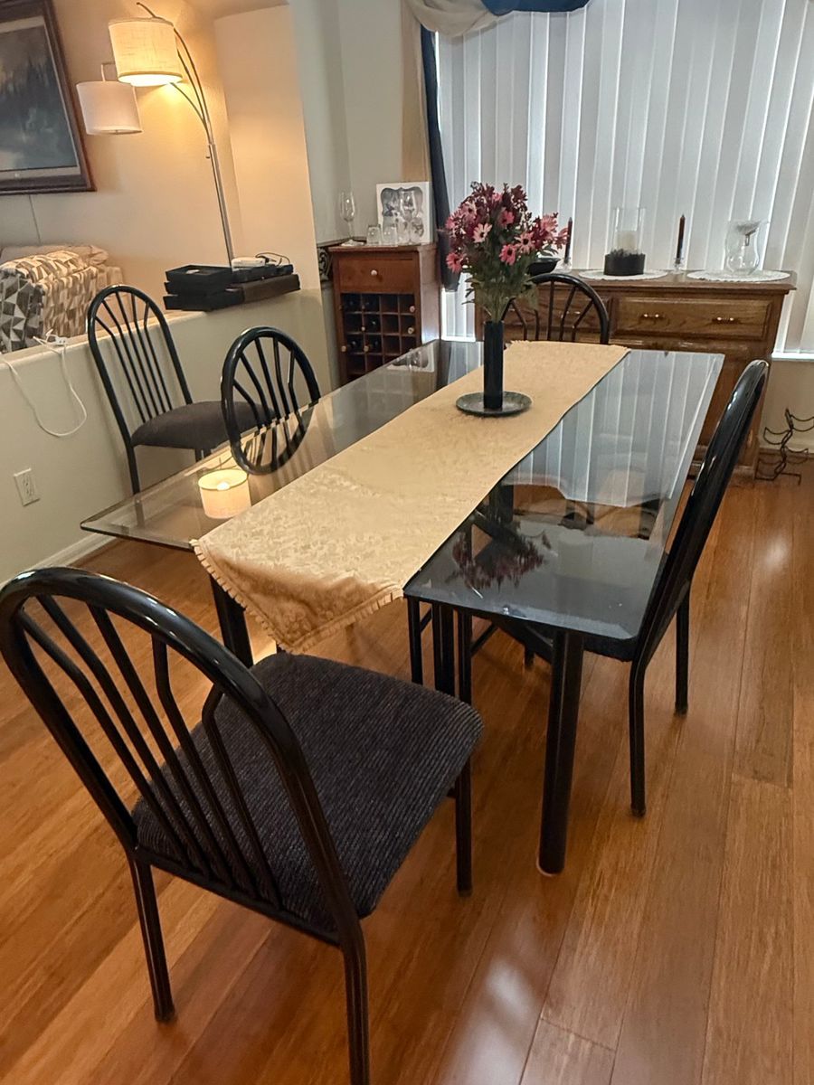 Modern Glass Top Dining Table with Black Metal Chairs