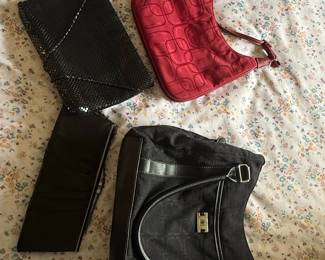 Assorted Women's Handbags: Black Mesh Evening Clutch, Red Embossed Shoulder Bag, and Black Embossed Tote
