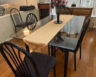 Modern Glass Top Dining Table with Black Metal Chairs