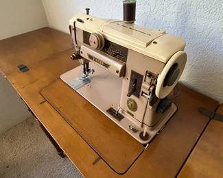 Singer sewing machine, cabinet and chair. 