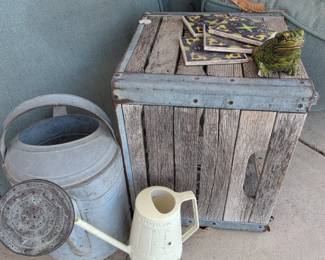 Vintage Galvanized Watering Can and Cream Colored Plastic Watering Can with Wooden Crate