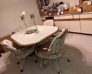 Great vintage (70's or 80's) cream and beige oval dinette table with wood trim and four upholdtered swivel chairs with wood trim and casters