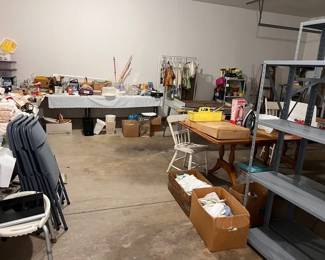 Garage is full of outdoor items, shelving units, garage product, tables linens, and more!