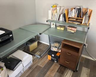 Glass corner desk also has a glass table