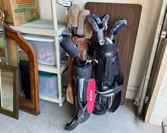 Three sets of golf clubs, men’s women’s and Child