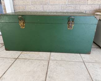 vintage green wooden footlocker or military style storage trunk