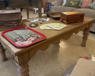 rustic wooden coffee table, couch, throw pillows, Coke adveritsing sign