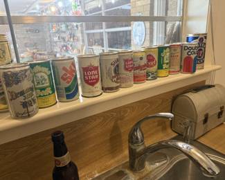 collection of metal beer cans and cola